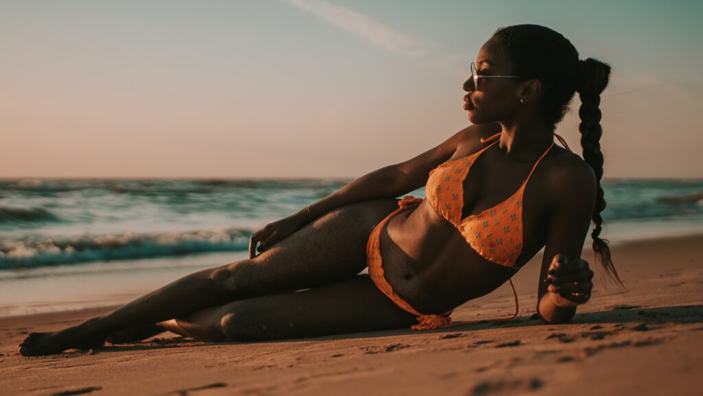 Swimwear for small busts. Black girl in bikini on beach. Swimsuit for beach or pool