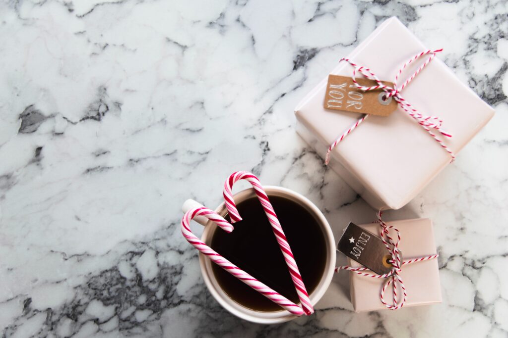 Christmas gifts for her. Pink Christmas presents with candy cane bows.