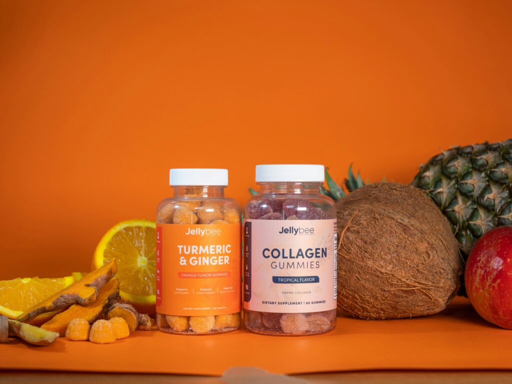 Wellness supplements sitting on a kitchen counter. Ginger, turmeric, and collagen vitamins.