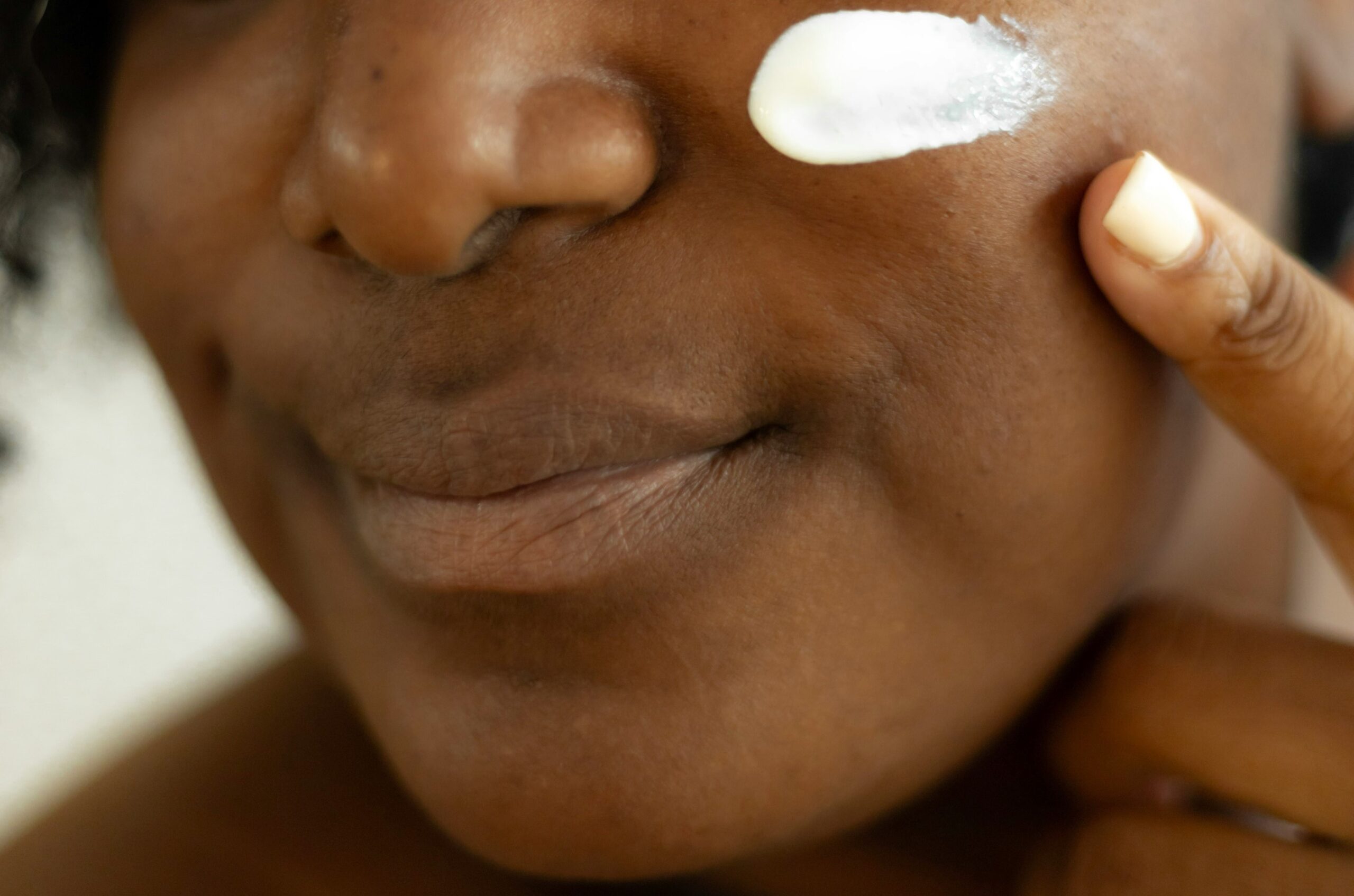 Skincare routine for large pores and textured skin. Black woman applying skincare. 